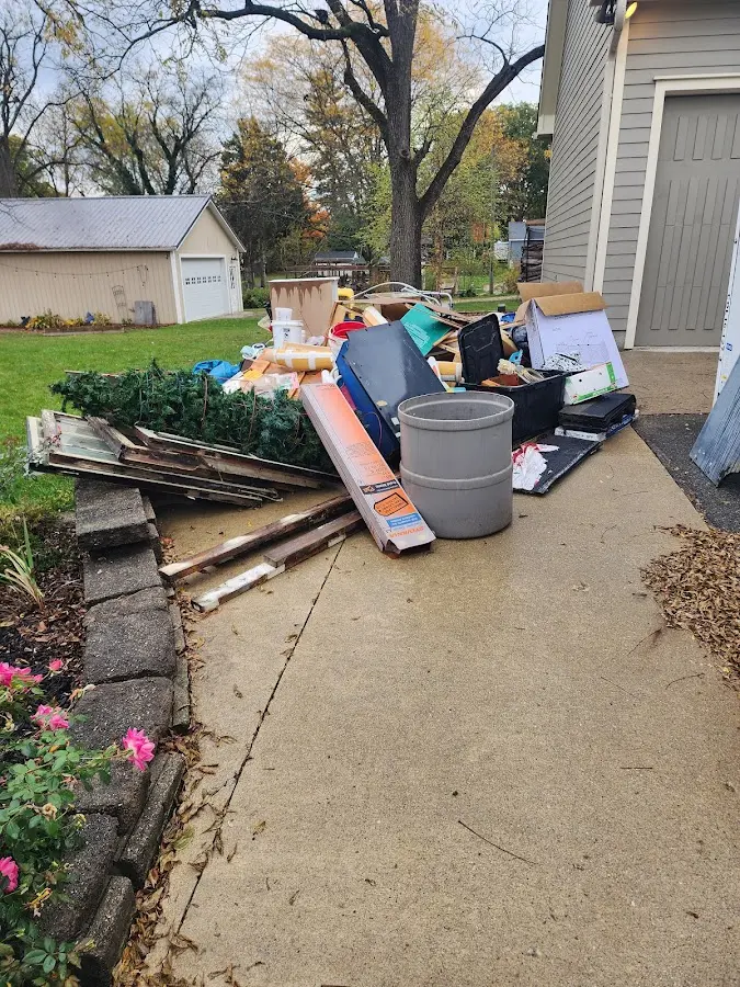 Dumpster being loaded with debris for Estate Cleanout Dumpster Rental in Powder Springs